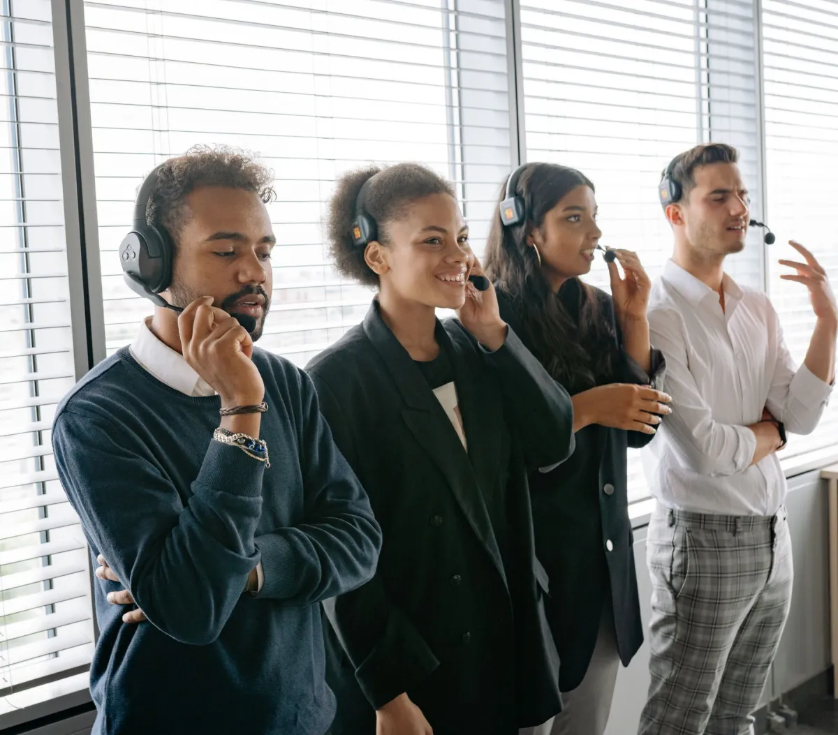 A team wearing headsets in a bright service workspace